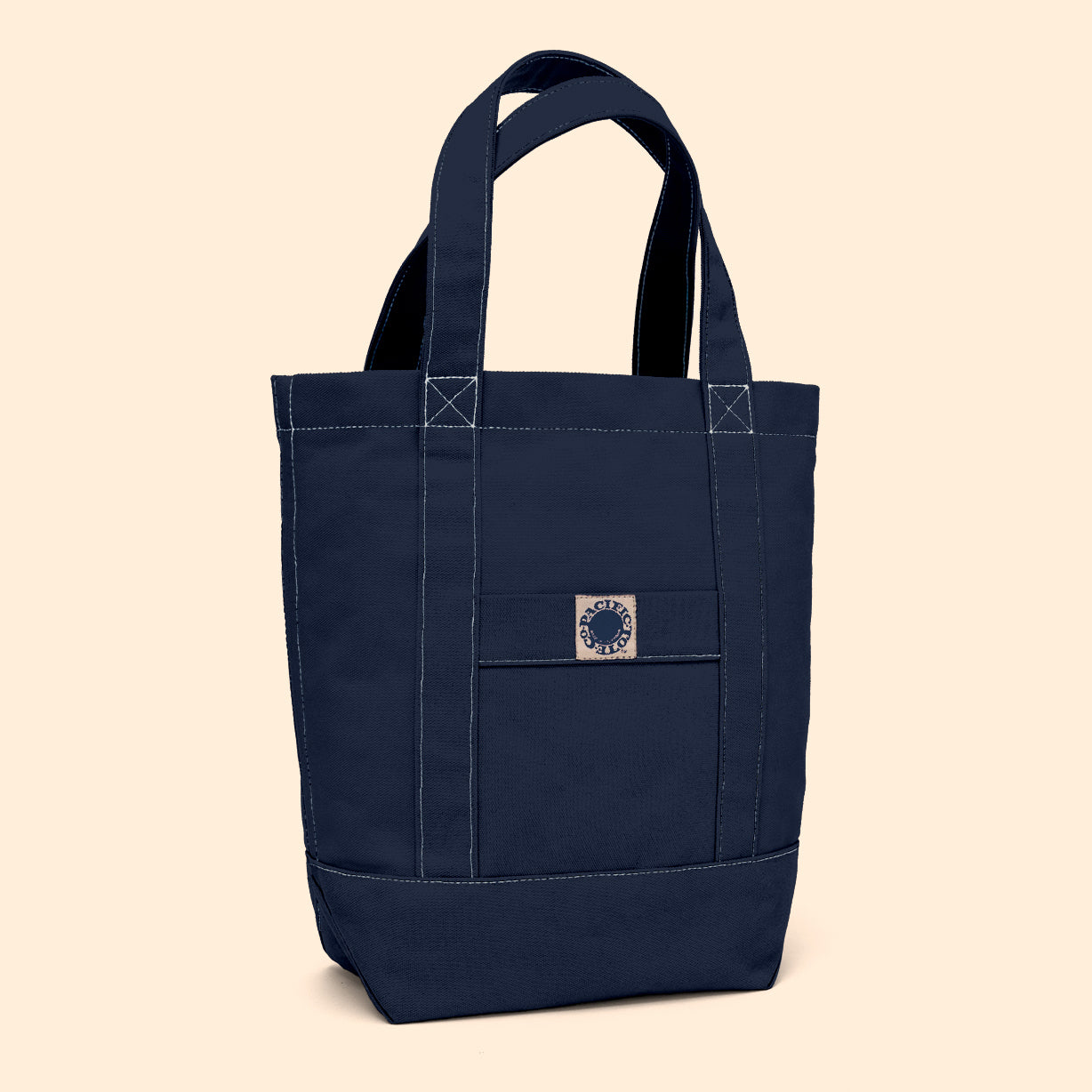 Navy blue tote bag with a logo on a beige background